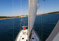 sailing yacht sailboat from bow mast sails deck skipper rigging